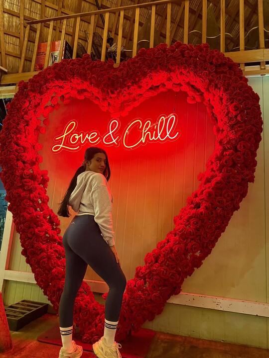 In front of a rose heart installation