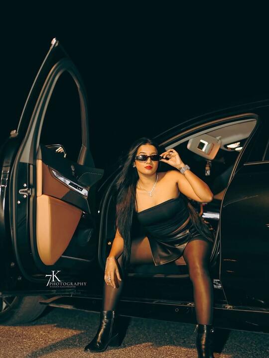 Standing in the doorway of the car
