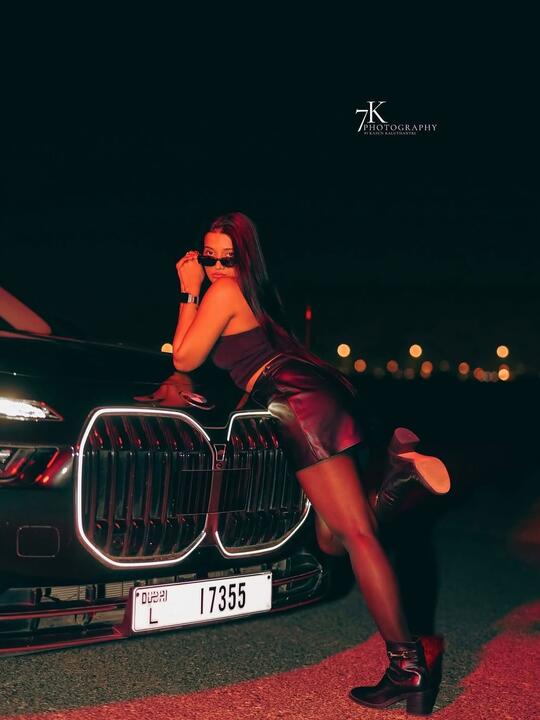 Across the front of the car, night
