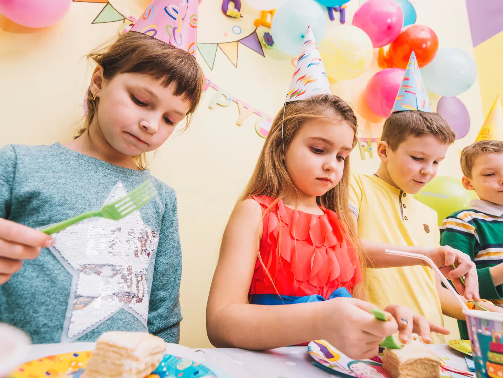 Children making things at a table covered with craft materials