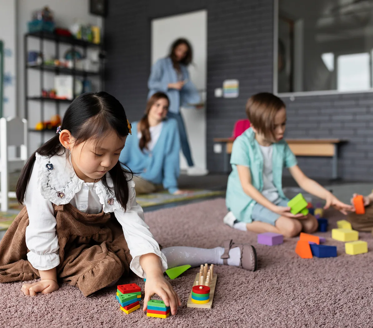 A child playing with building blocks on the floor