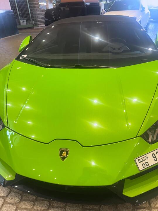 A green supercar parked up