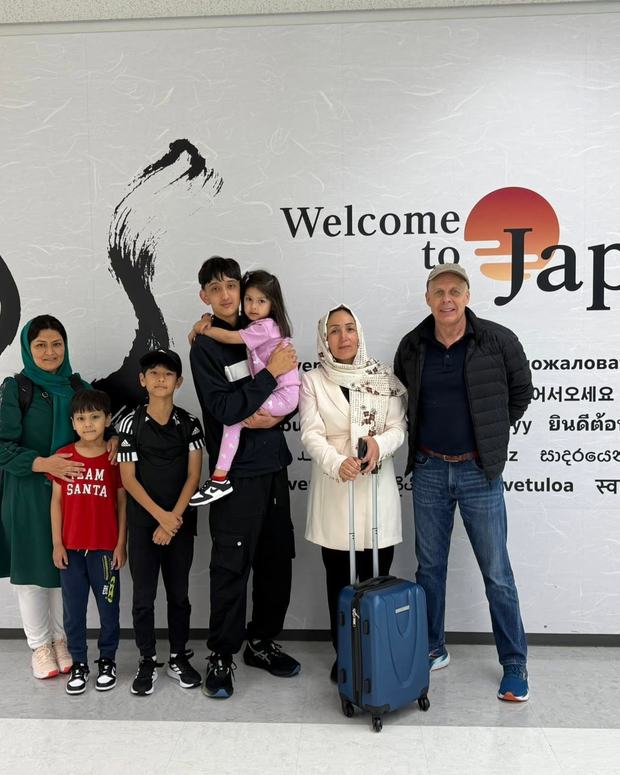 WSKF Australia members arriving at a Japanese airport beneath a Welcome to Japan sign